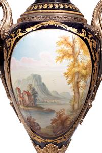A Pair of Monumental Sèvres Style Gilt Metal Mounted Porcelain Covered Urns on Pedestals