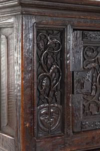 A Gothic Revival Carved Oak Cabinet on Stand