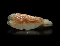 A Chinese Carved Russet and Pale Celadon Jade Boulder