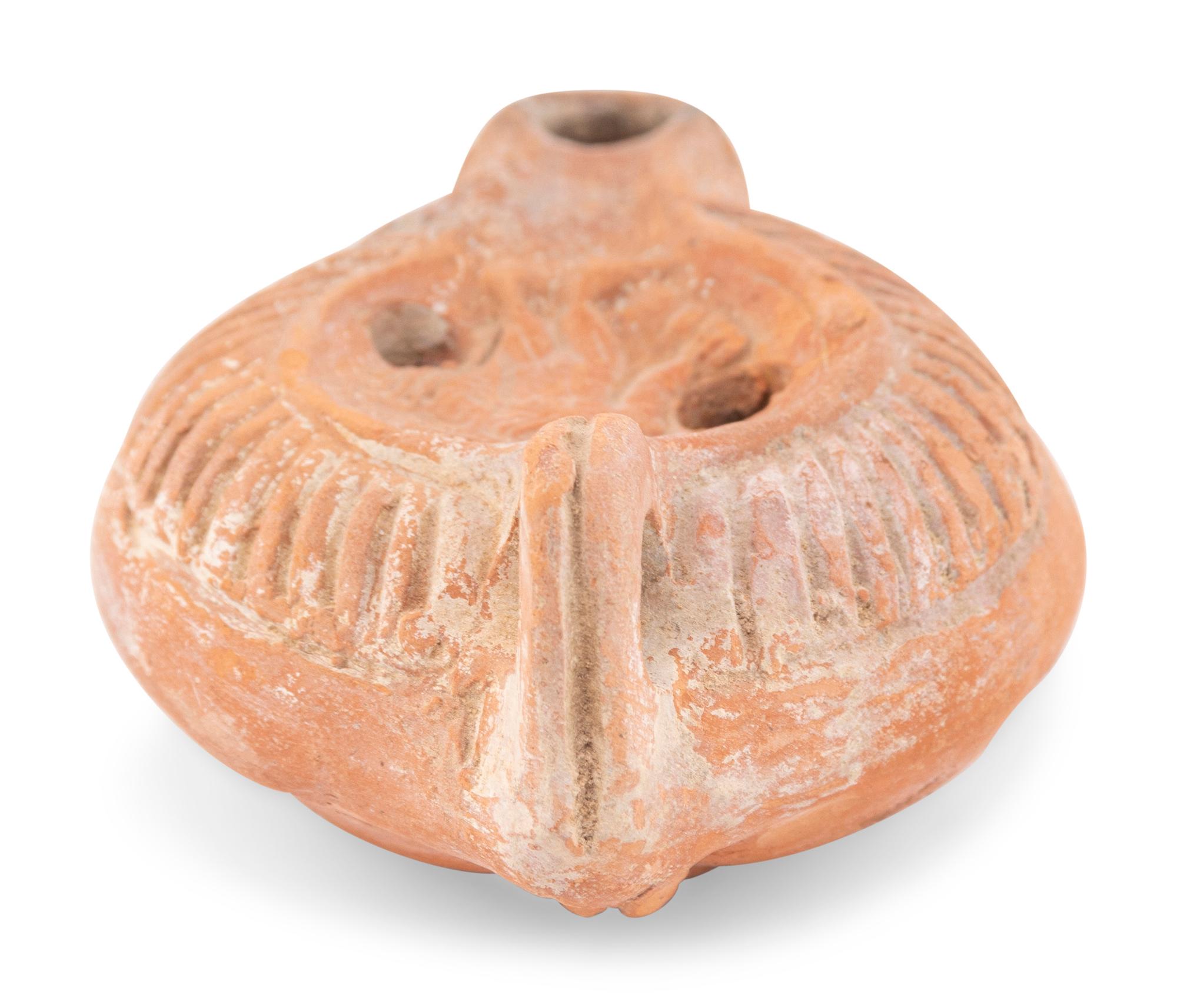 A Roman Terracotta Discus Lamp Depicting the God Hermes