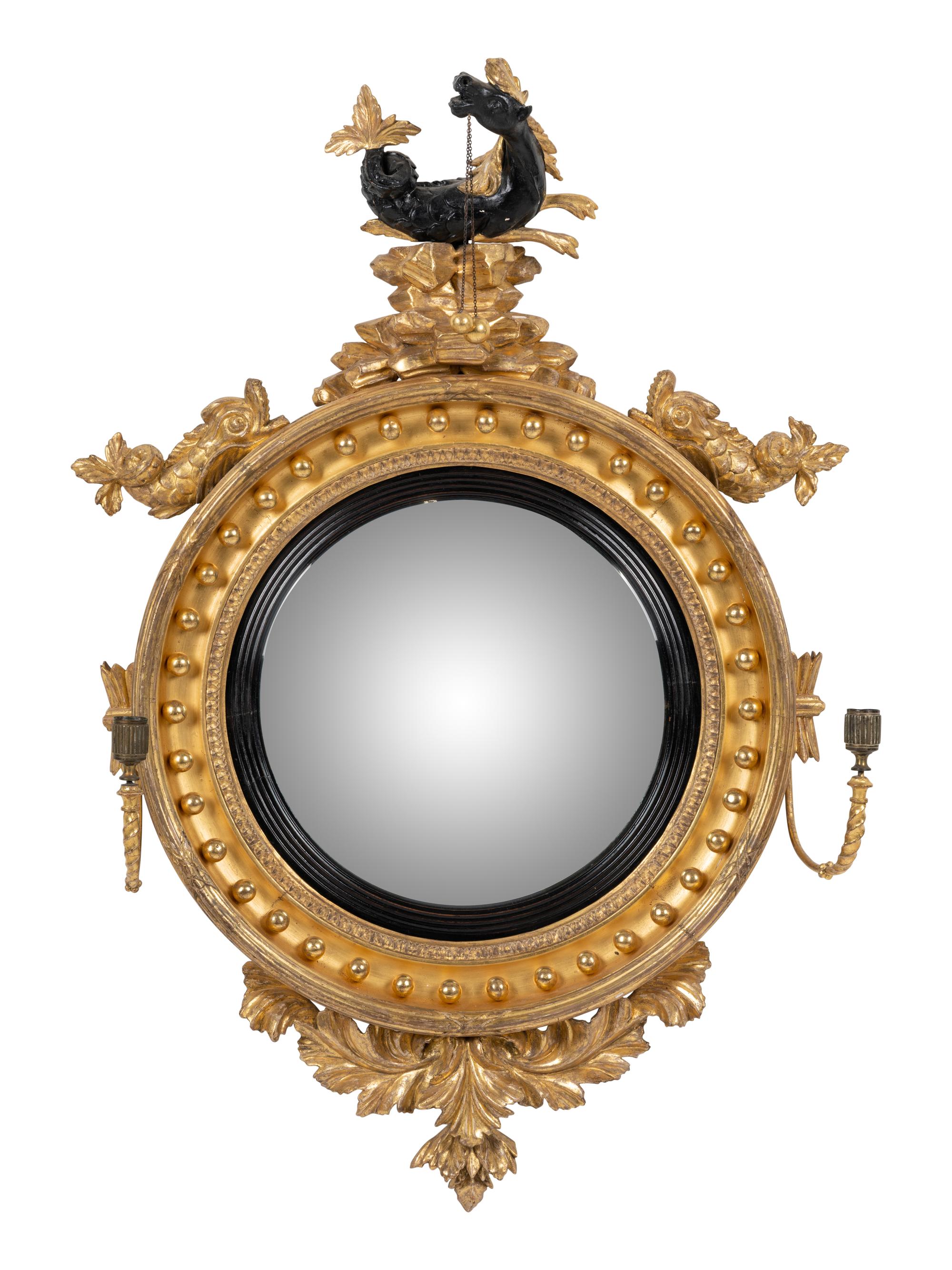 A Regency Parcel Ebonized Giltwood Convex Girandole Mirror
