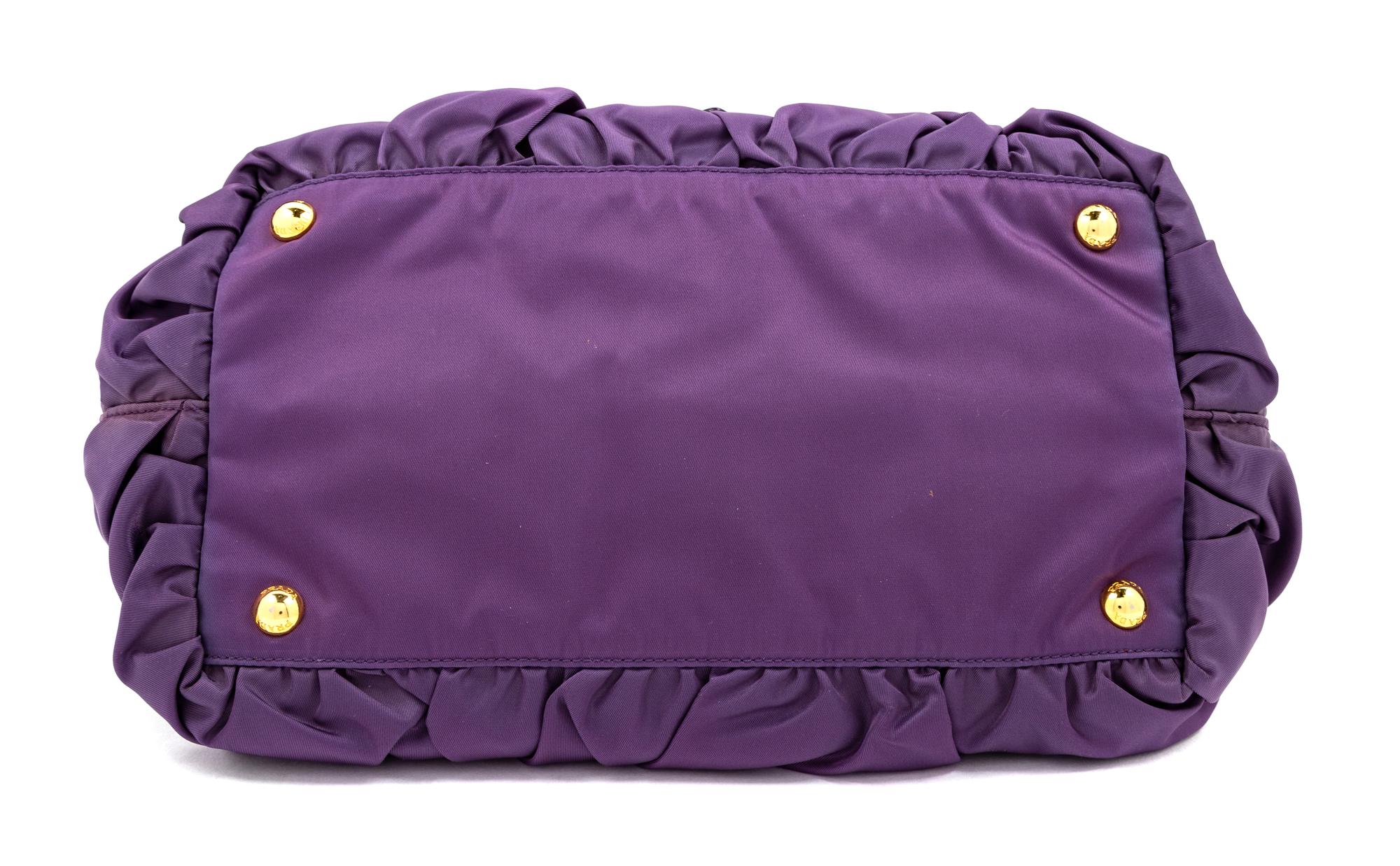 A Prada Purple Tessuto Nylon Origami Handbag with Leather Gloves and Earmuffs, Handbag: 7.5" H x 14" W x 8.25" D; Handle drop: 4.25". G