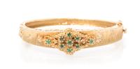 A 14 Karat Yellow Gold and Emerald Bangle Bracelet, 13.10 dwts.