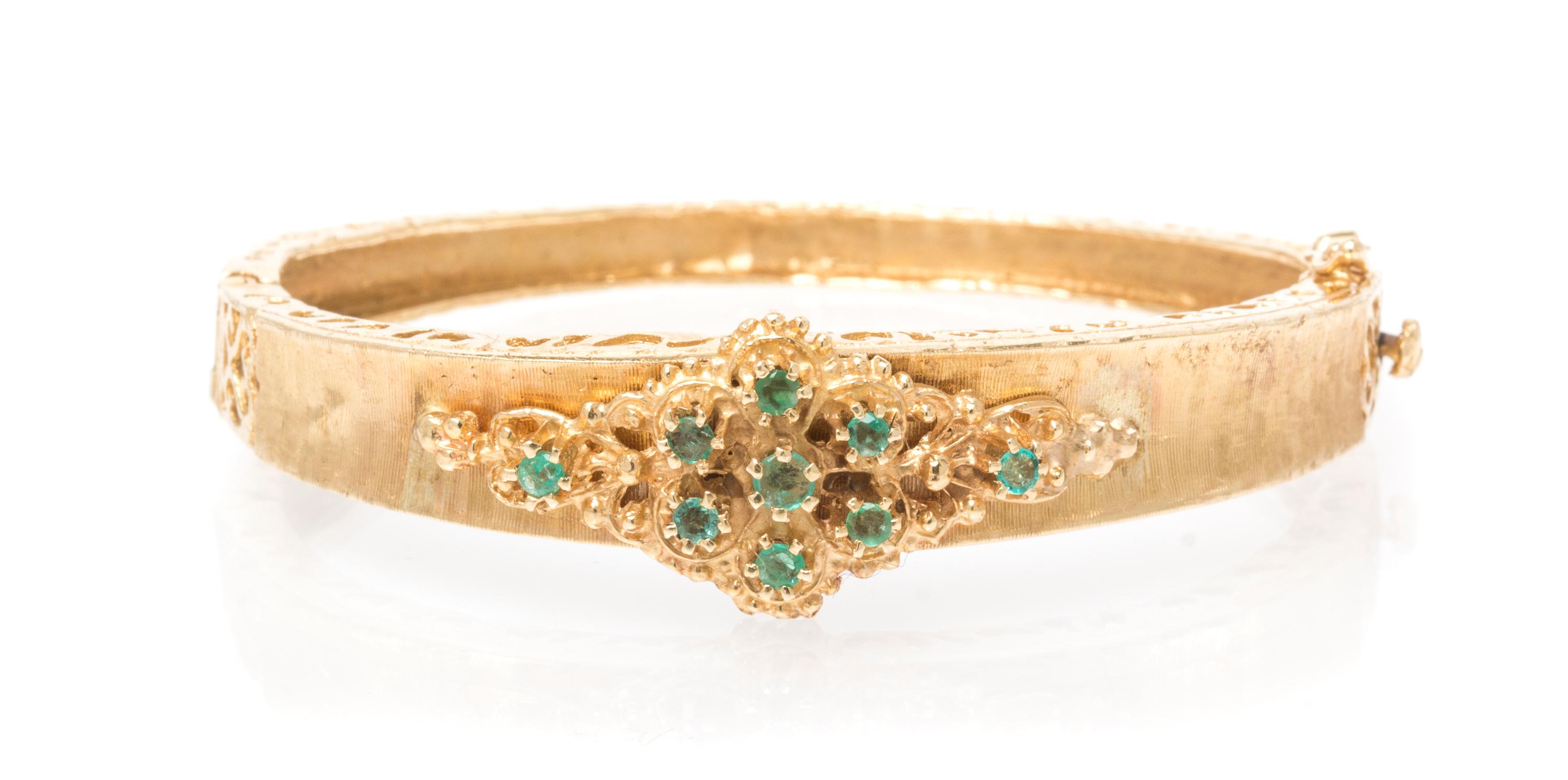 A 14 Karat Yellow Gold and Emerald Bangle Bracelet, 13.10 dwts.