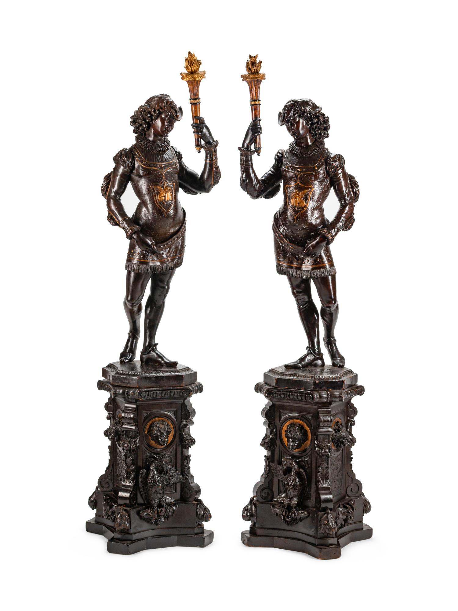 A Large Pair of English Parcel-Gilt and Stained Wood Figural Torchères on Stands