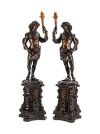 A Large Pair of English Parcel-Gilt and Stained Wood Figural Torchères on Stands
