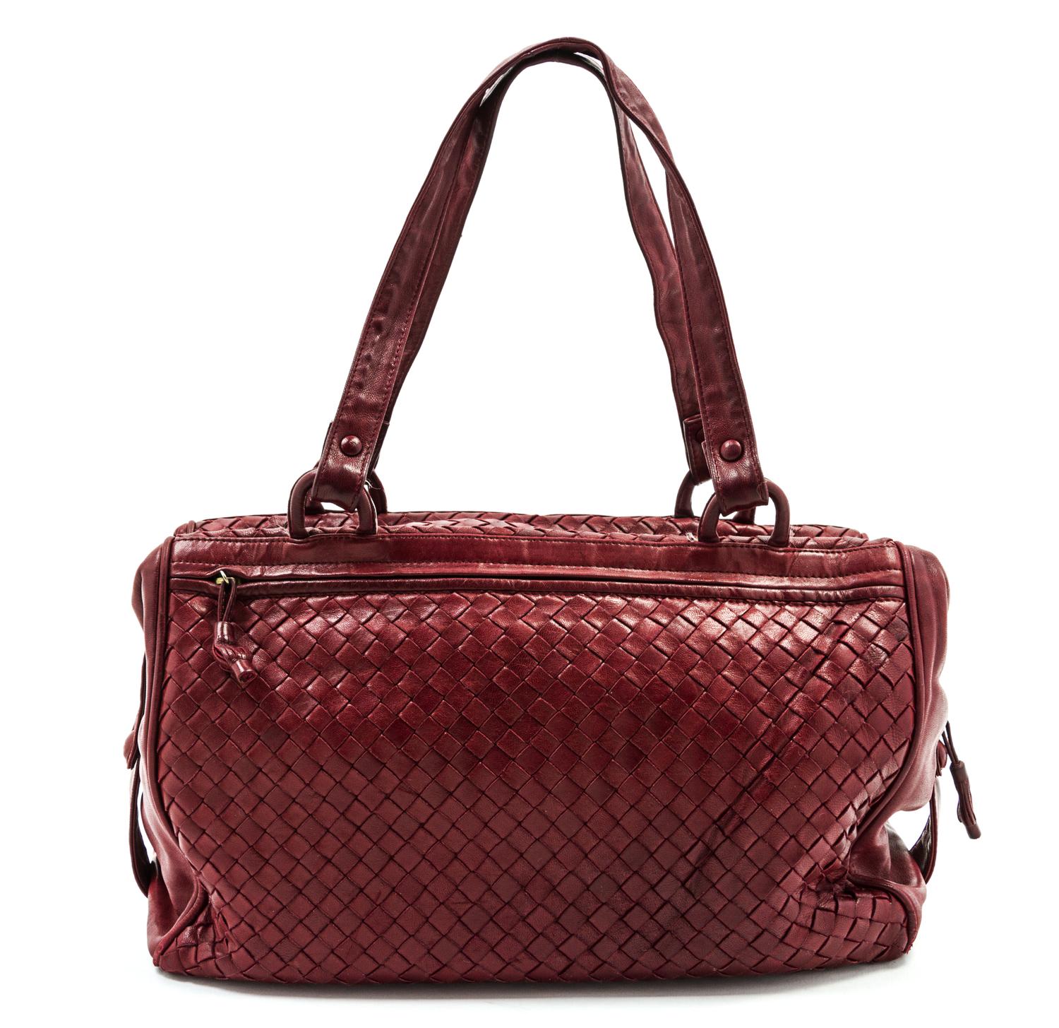 A Bottega Veneta Burgundy Intrecciato Leather Duffle Bag, 14 x 8 x 6 inches.