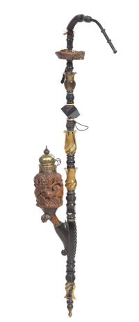 A Carved Walnut and Horn Opium Pipe Length 38 inches.