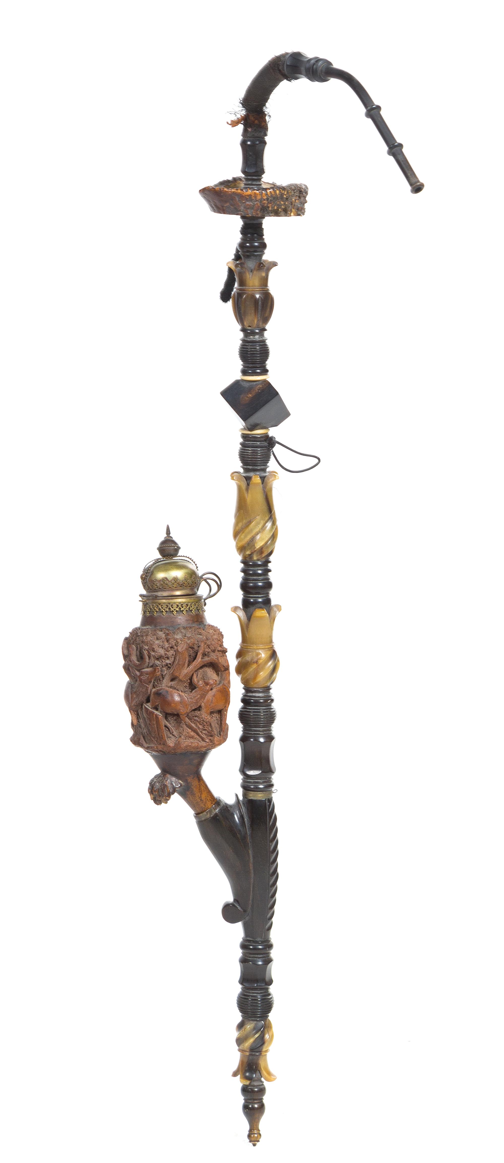 A Carved Walnut and Horn Opium Pipe Length 38 inches.
