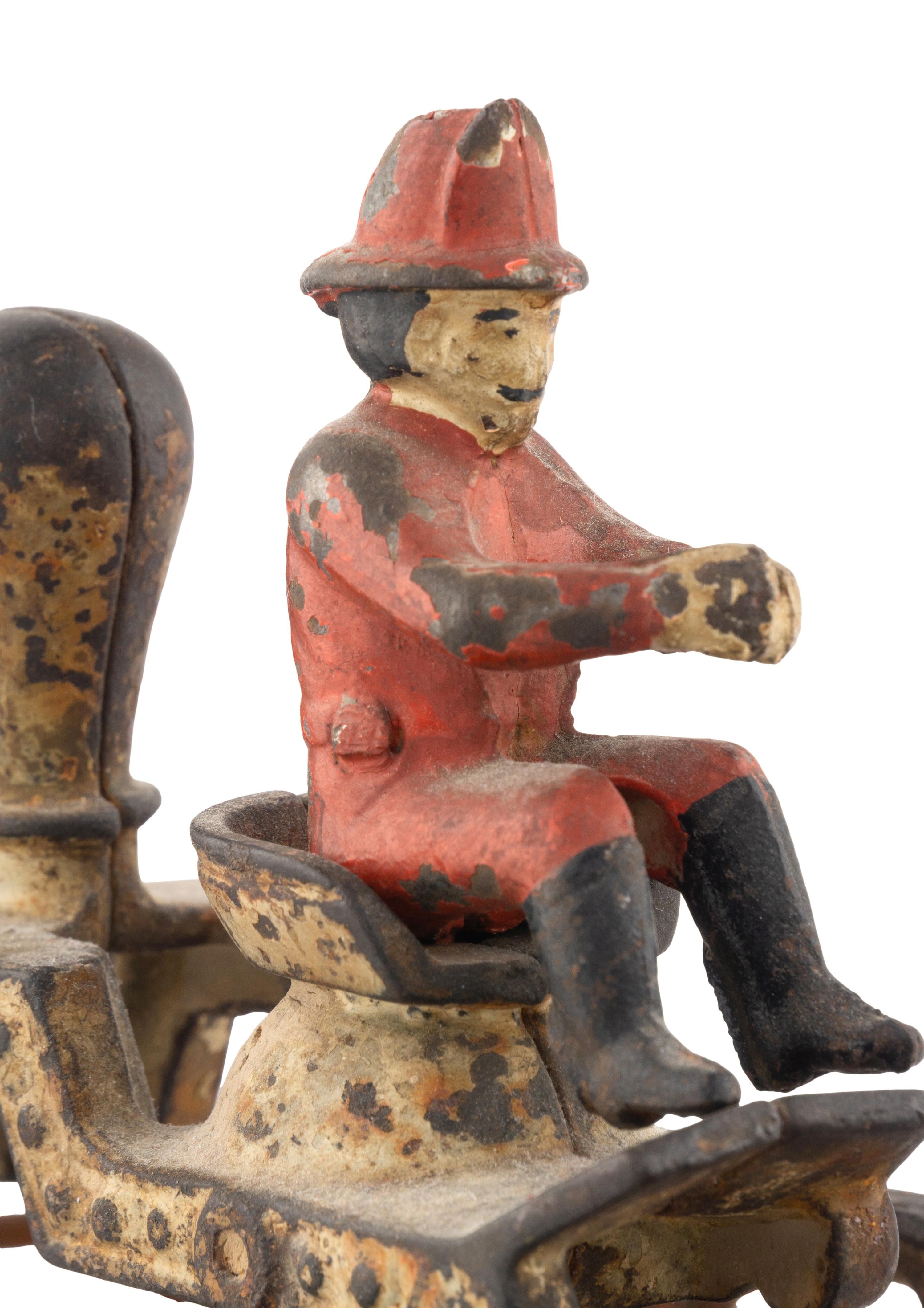 A Cast Iron Fire Engine Three-Horse Train and a Horse Pull Toy