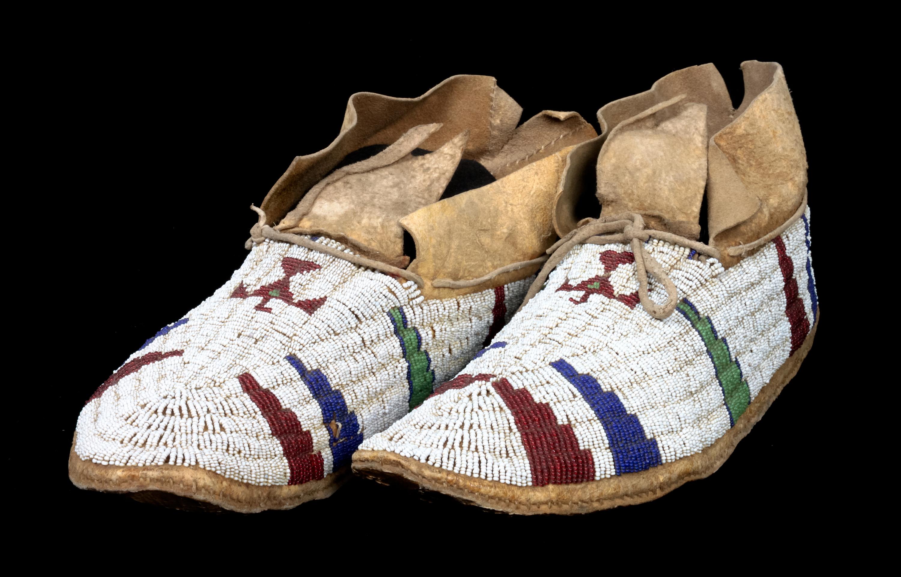 A Pair of Cheyenne Fully Beaded Moccasins Length 10 1/2 inches.