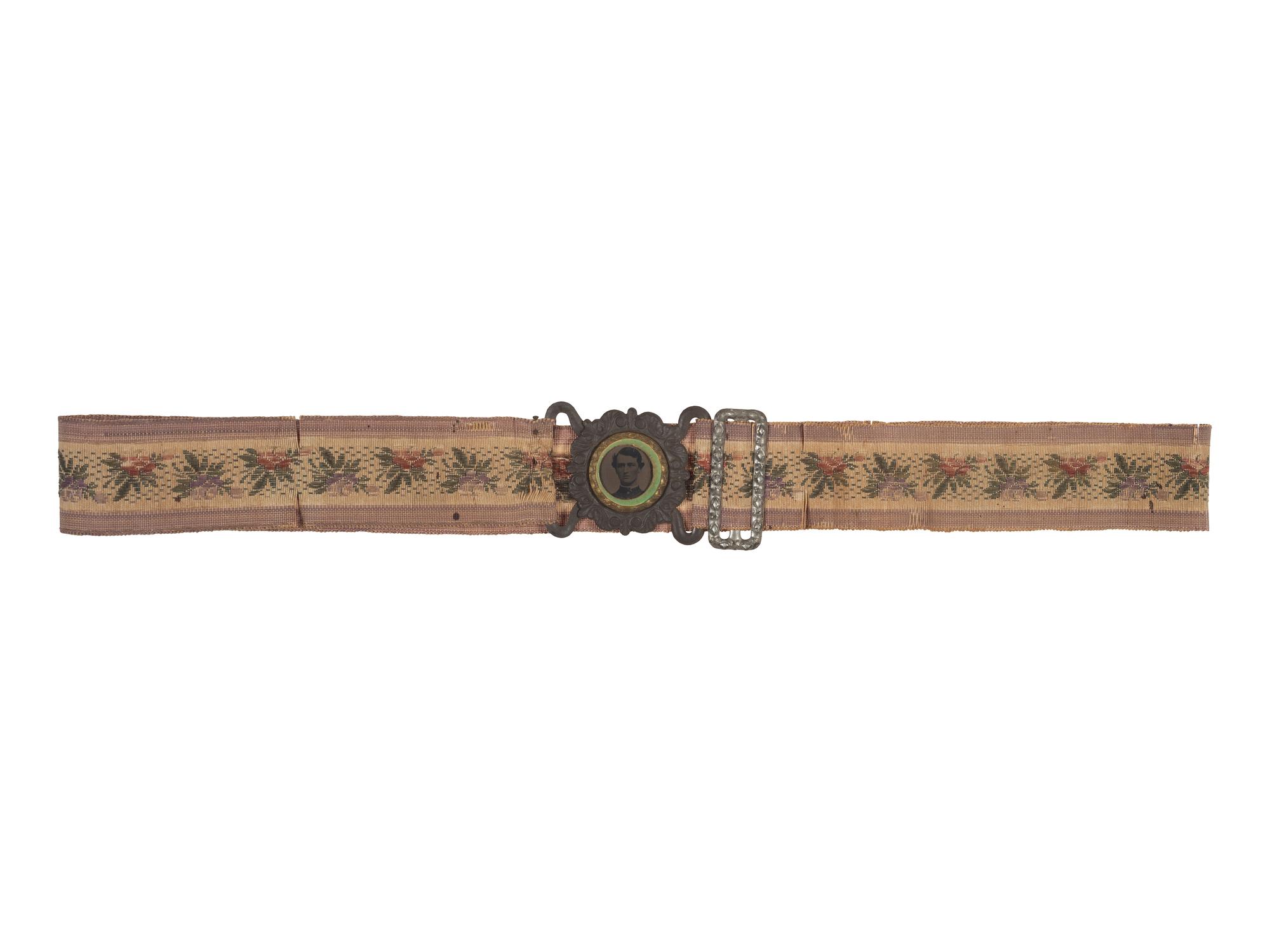 [CIVIL WAR]. Woman's woven belt with buckle containing gem-size tintype of a Civil War soldier.