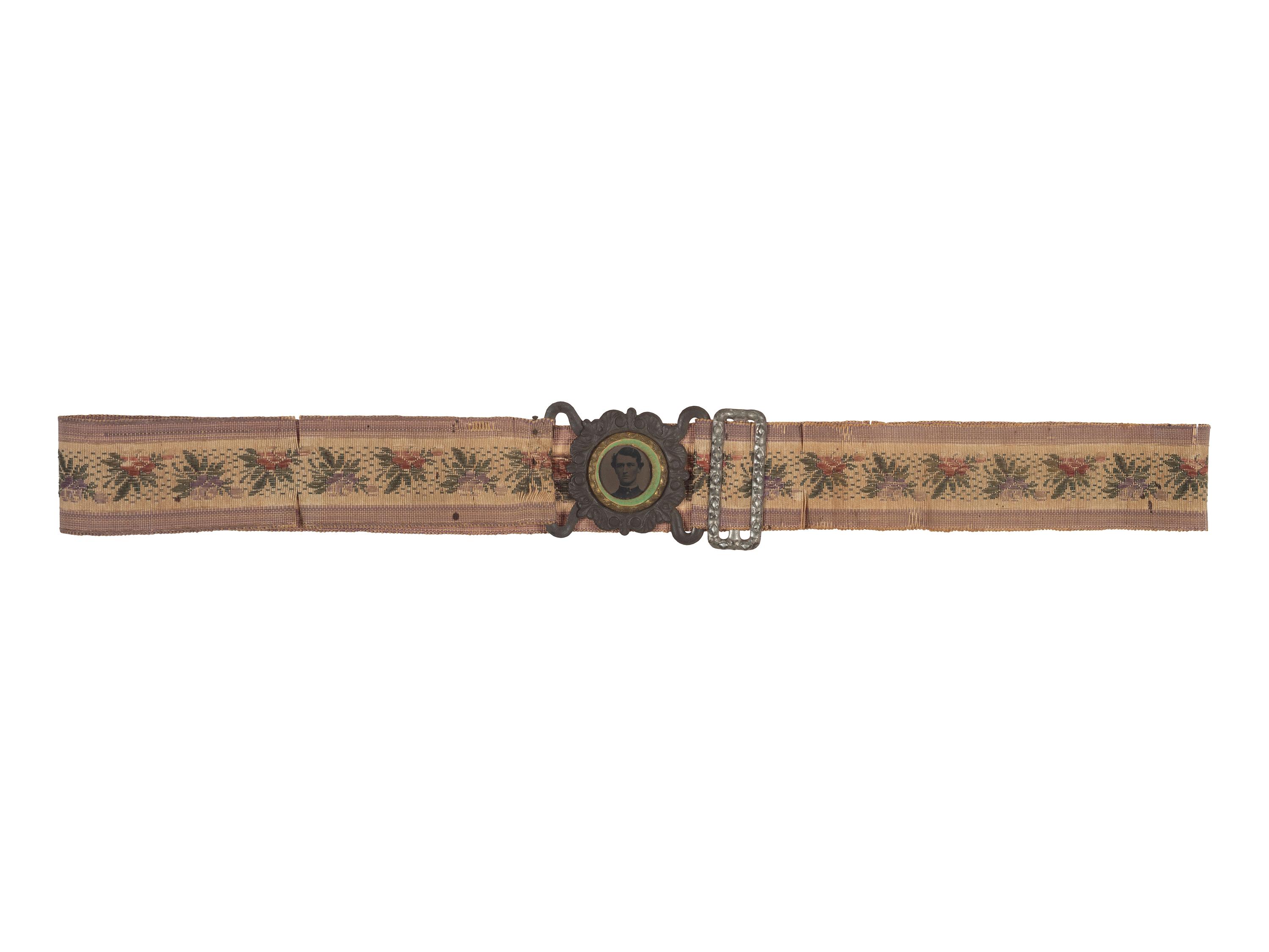 [CIVIL WAR]. Woman's woven belt with buckle containing gem-size tintype of a Civil War soldier.