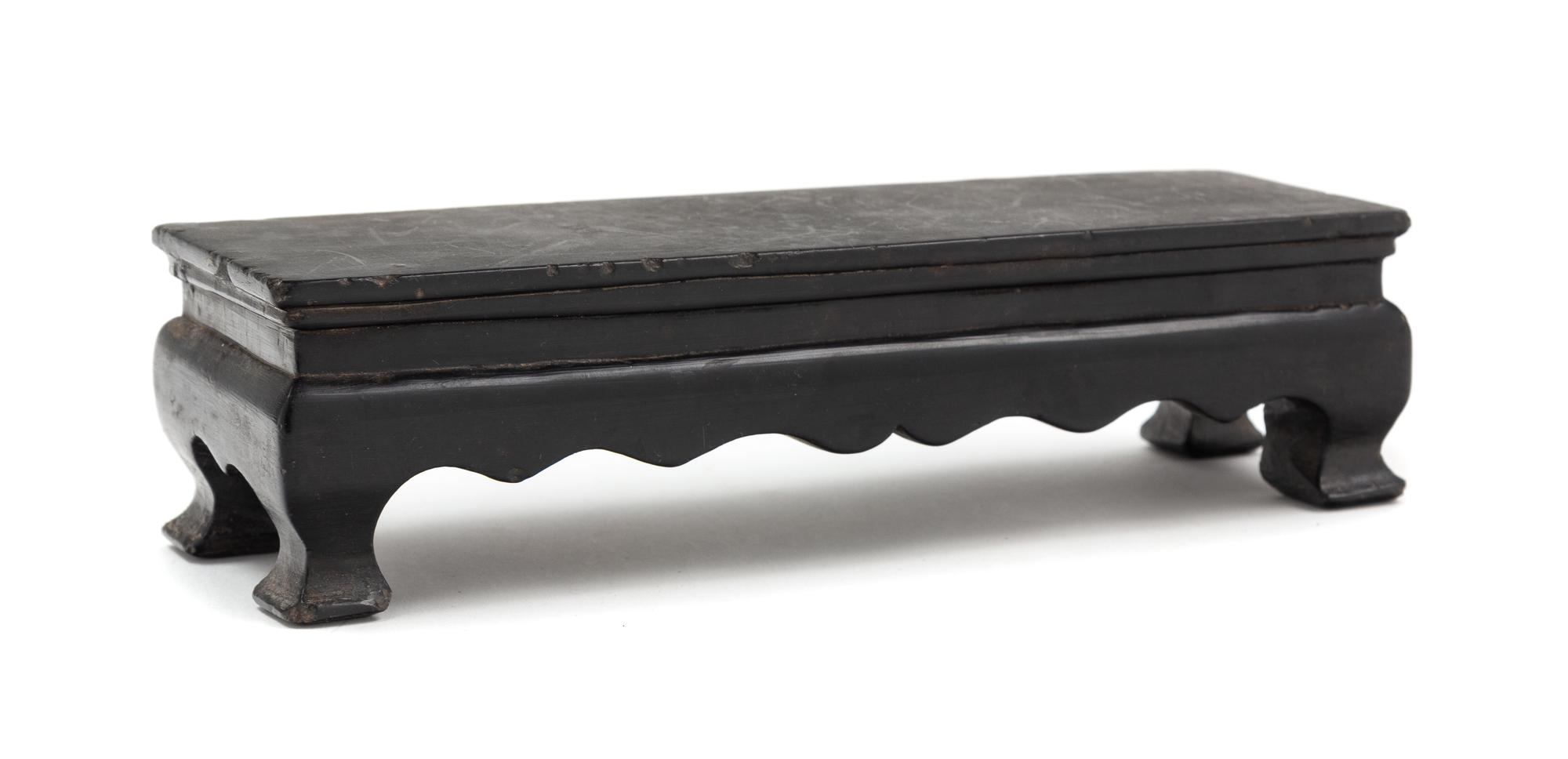 A Chinese Black Hardstone Stand Length 8 1/4 inches. — 20TH CENTURY