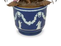 A Wedgwood Jasperware Cache Pot with a Tole and Porcelain Flower Arrangement