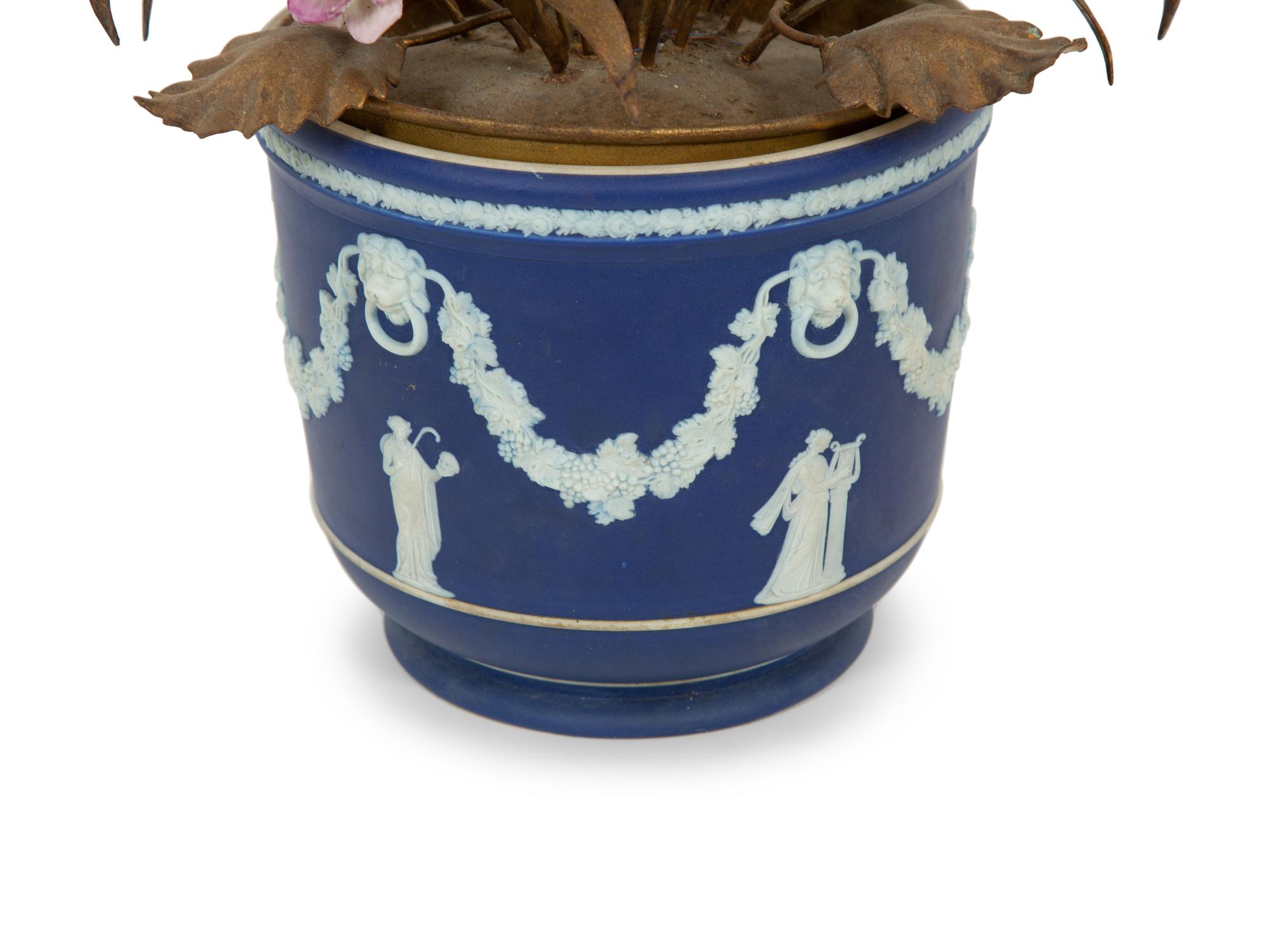 A Wedgwood Jasperware Cache Pot with a Tole and Porcelain Flower Arrangement