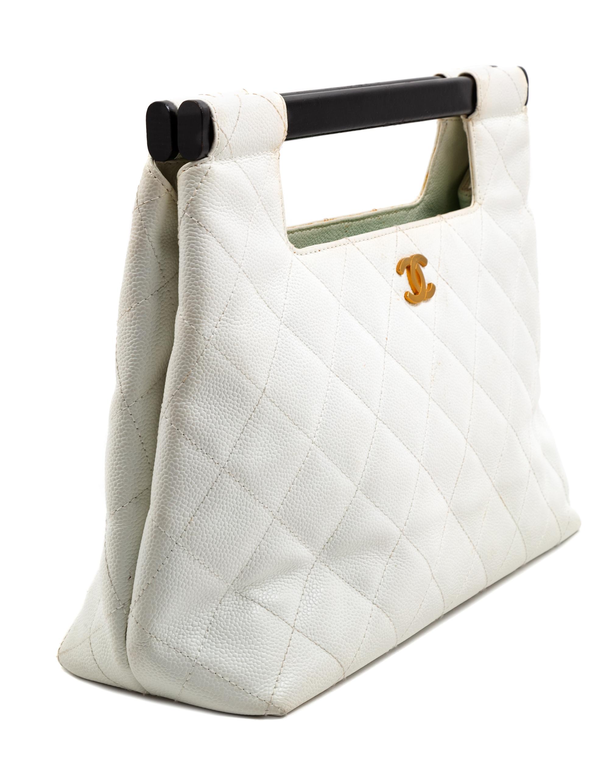 A Chanel White Caviar Quilted Melrose Cabas Wood Handle Bag, 10.5" H x 13.5" W x 4.5" D; Handle drop: 2".