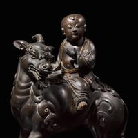 A Chinese Patinated and Parcel-gilt Bronze 'Qilin and Boy' Censer, 17th/18th Century 清早期 銅局部鎏金麒麟童子香薰