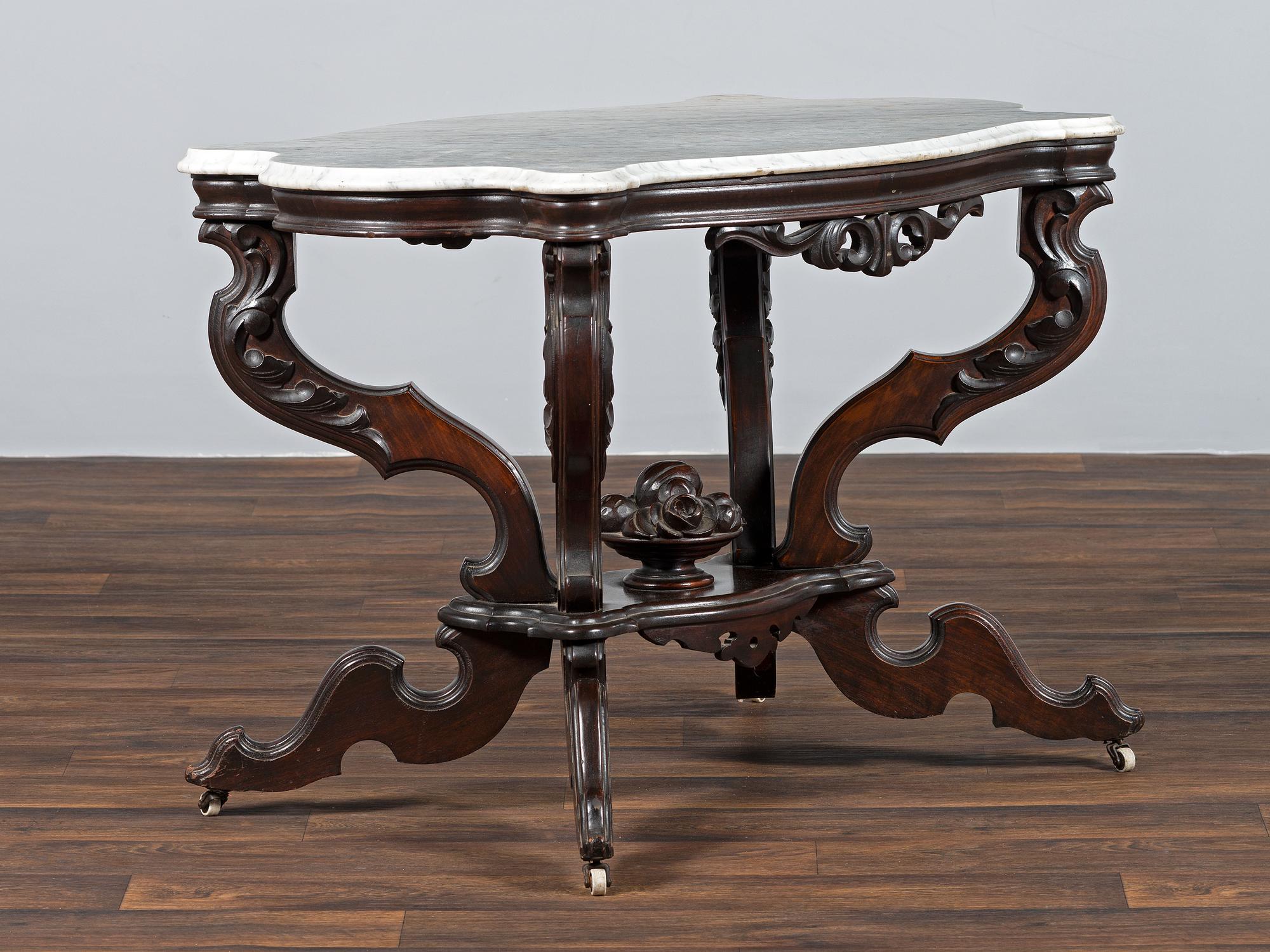 A Renaissance Revival Carved Walnut Marble Top Center Table