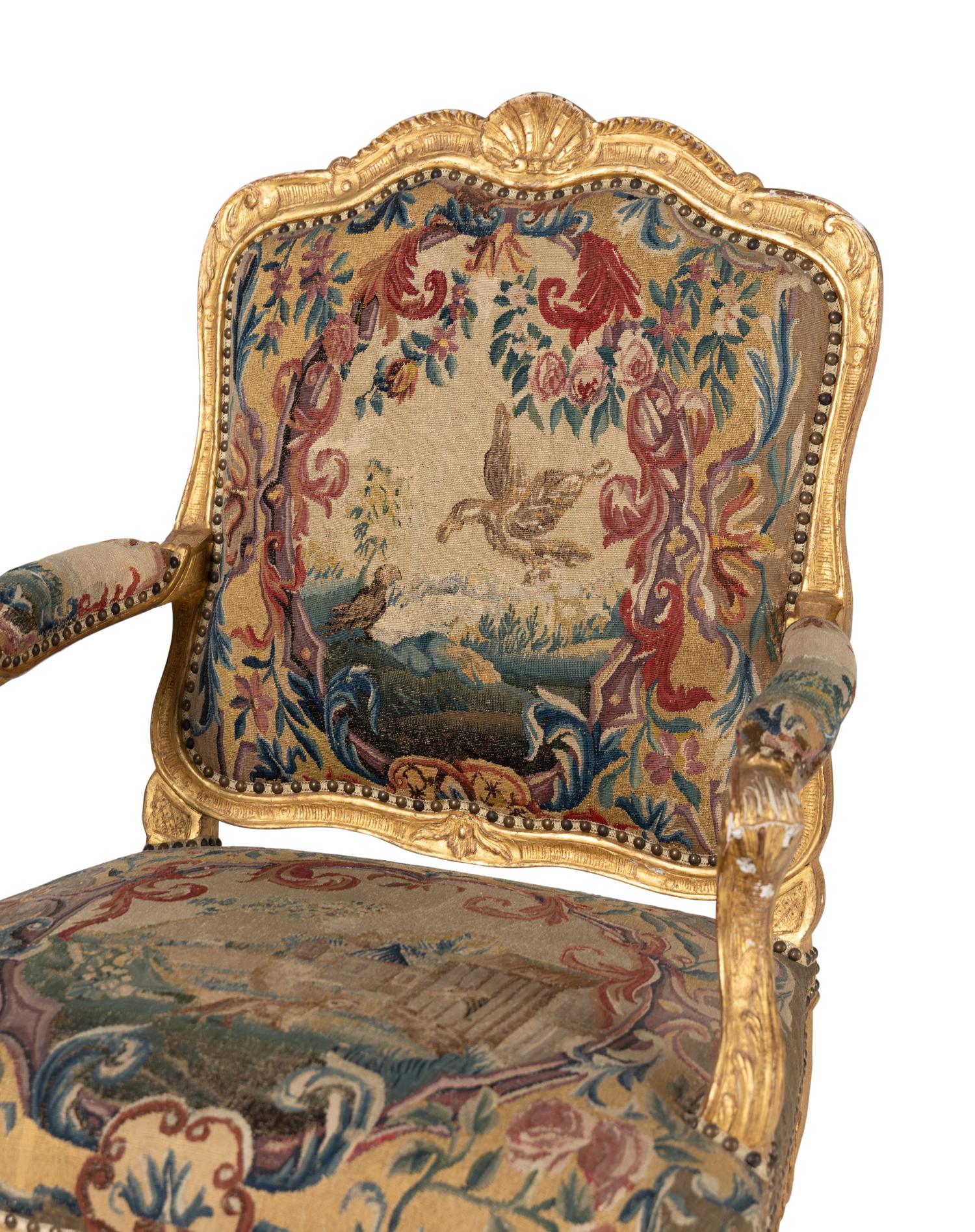 A Pair of Régence Tapestry-Upholstered Giltwood Fauteuils