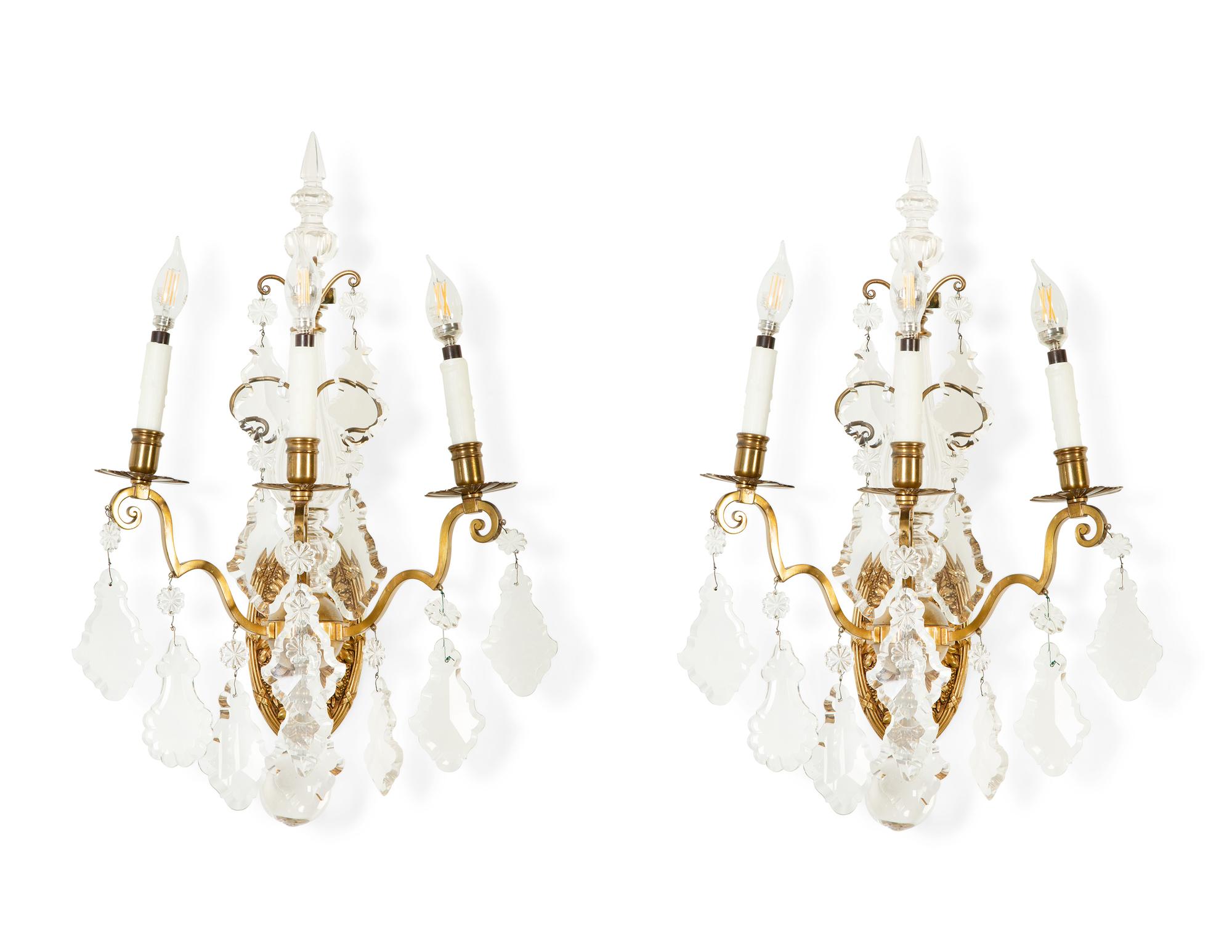 A Pair of Louis XV Style Gilt Bronze and Cut Glass Three-Light Sconces