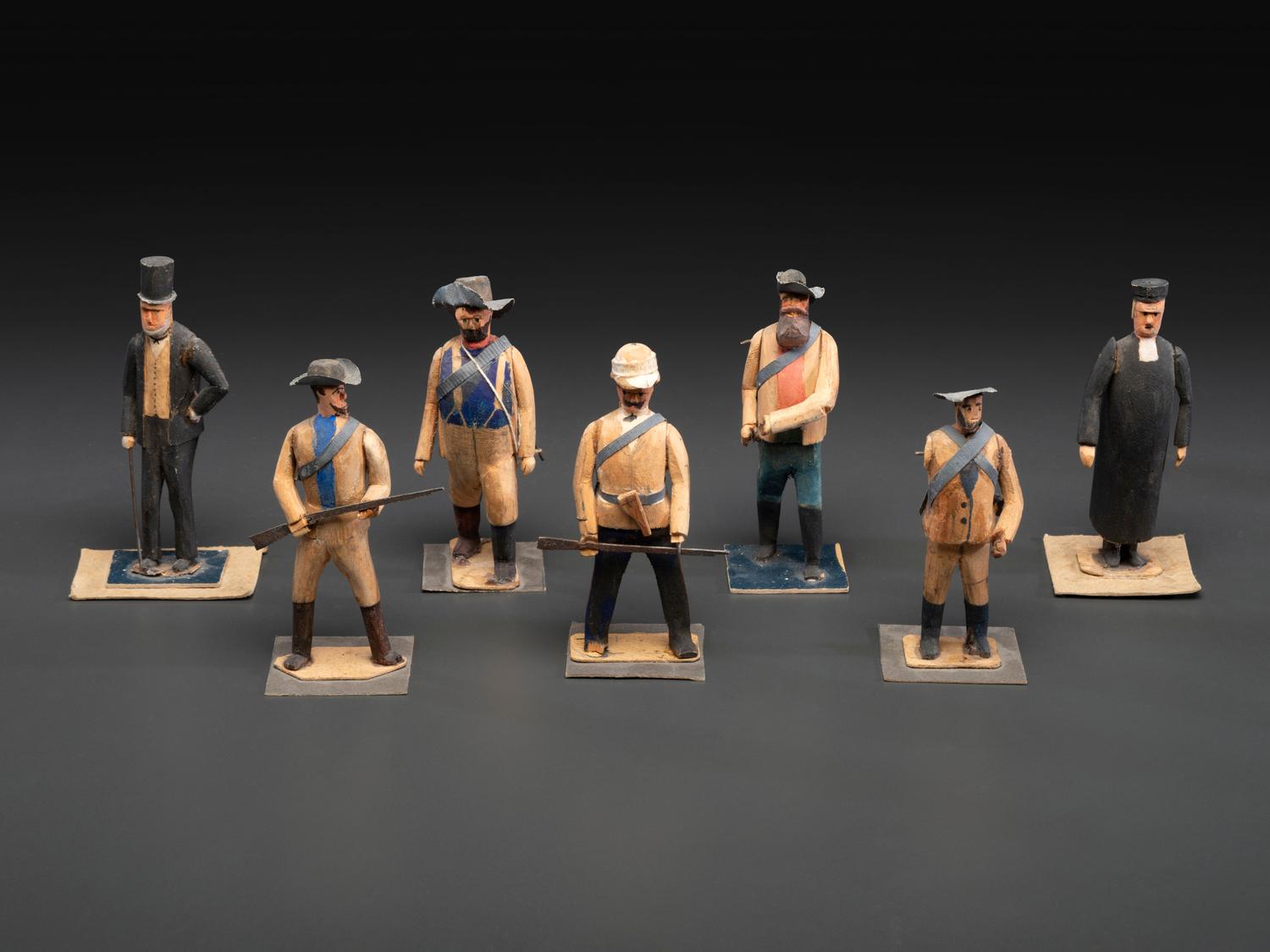 A Collection of Folk Art Carved and Painted 'English Parade' Figures