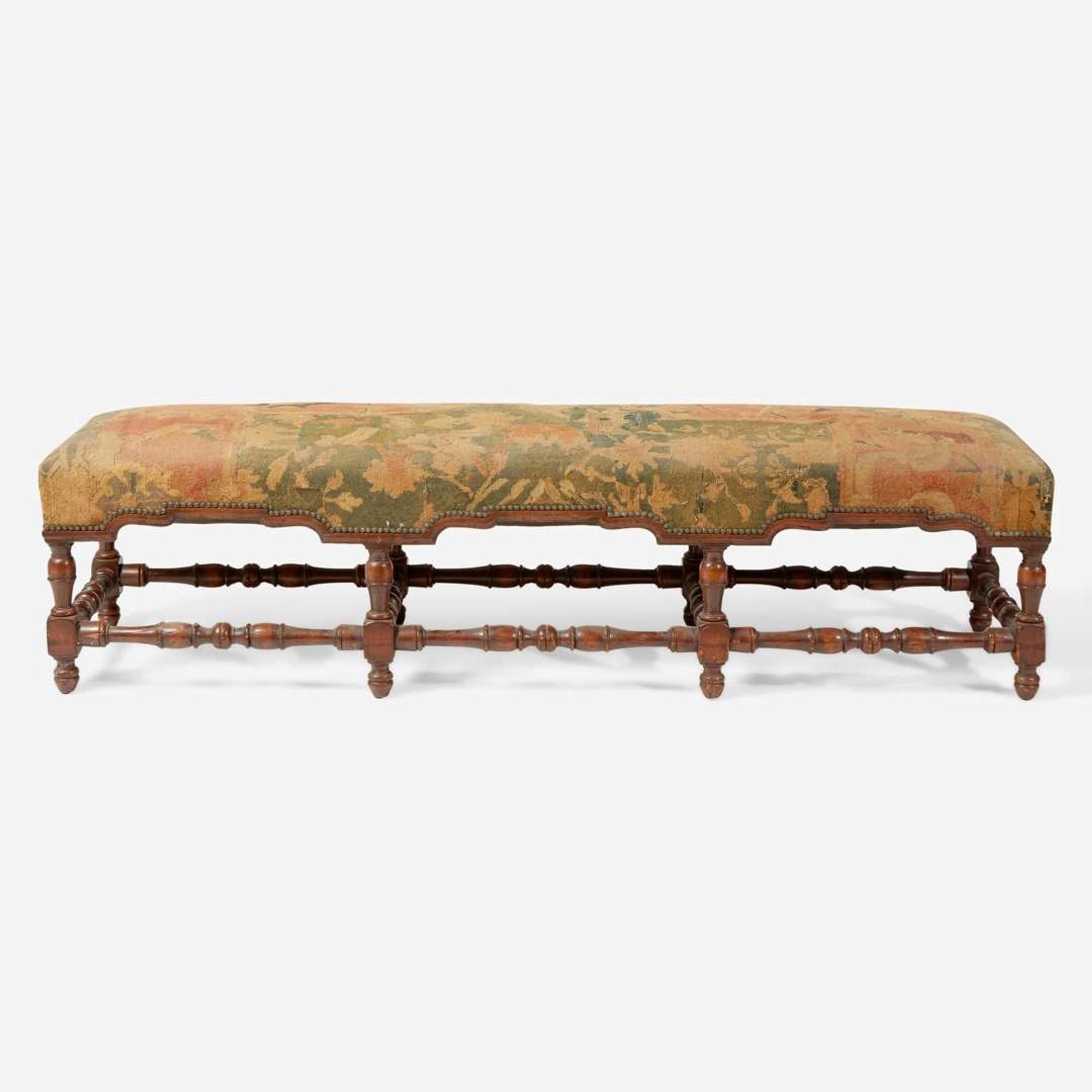 A Baroque Revival carved walnut bench with kilim upholstery late 19th / early 20th century