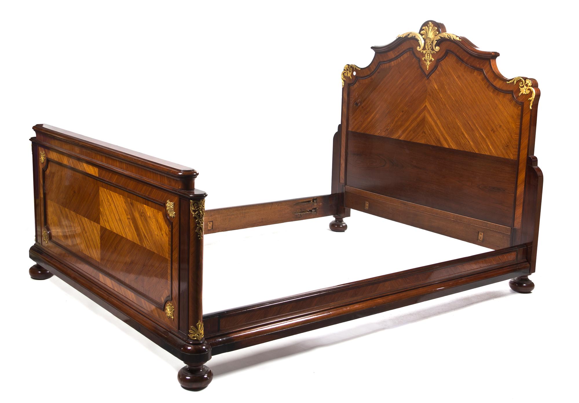 A Louis XV Transitional Style Kingwood, Mahogany, Parquetry and Gilt Bronze Mounted Bed, Height 63 x width 80 x depth 60 inches.