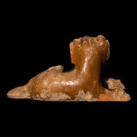 A Chinese Straw Glazed Pottery Figure of a Recumbent Dog, Han Dynasty 漢 陶臥犬