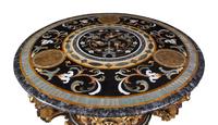 A Continental Parcel Gilt and Ebonized, Pietra Dura and Abalone Inlaid Center Table