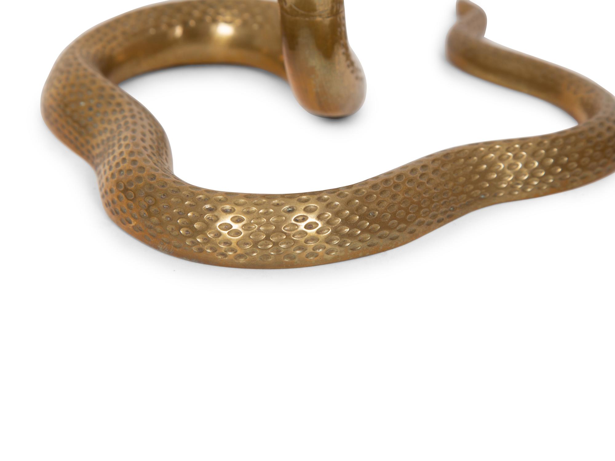 A Pair of Brass Cobra Candlesticks