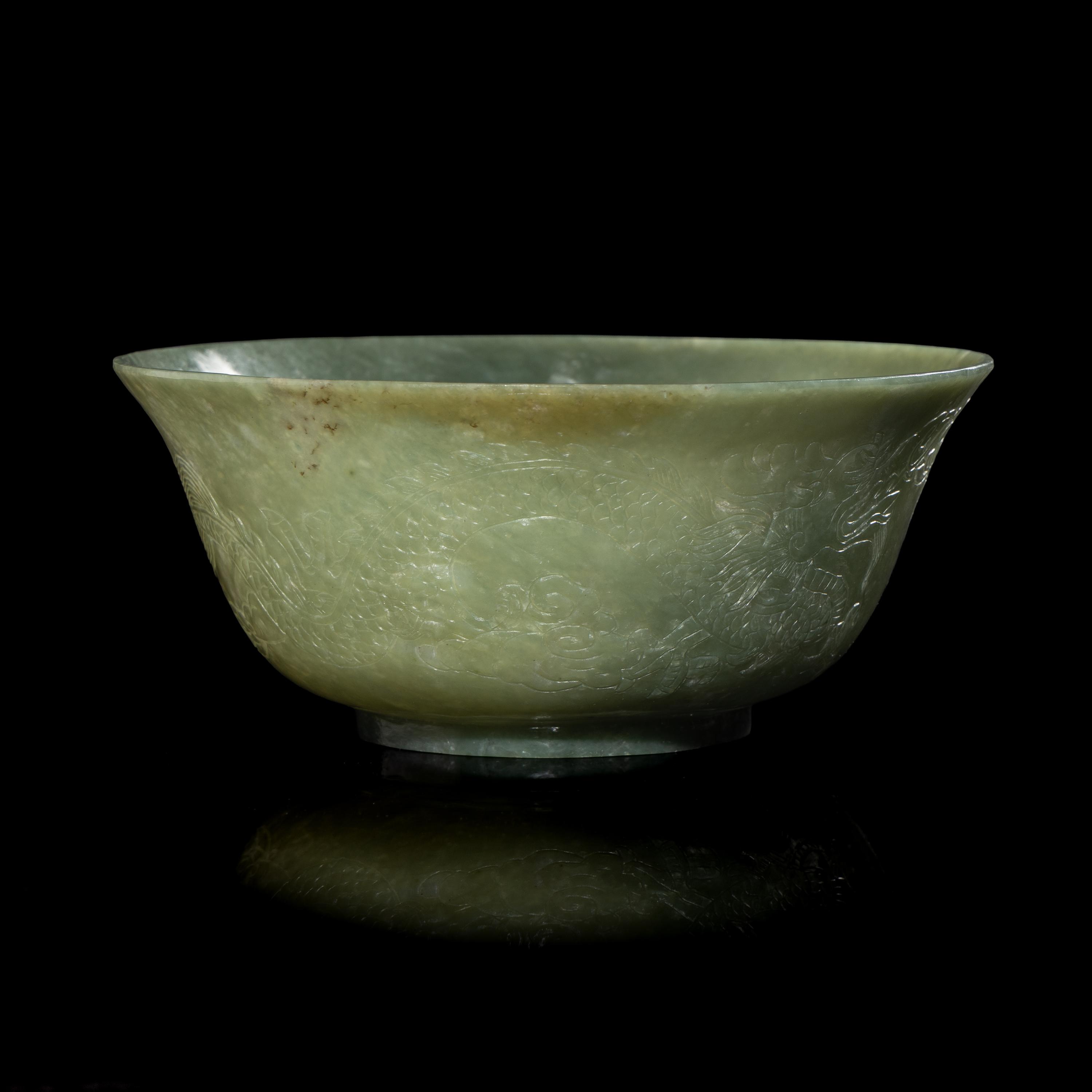 A Chinese Celadon Jade 'Dragon' Bowl, 20th Century 近代 青玉刻龍紋碗