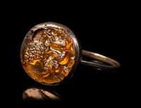 A Roman Silver and Glass Finger Ring of a Satyr Kissing a Goat