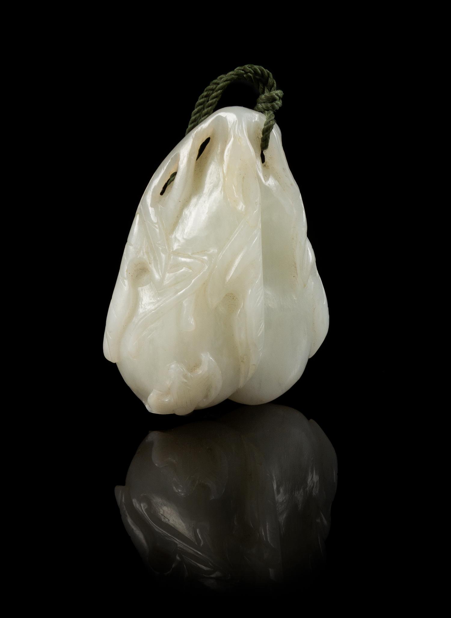 A Carved Jade Pendant Length 2 1/4 inches.