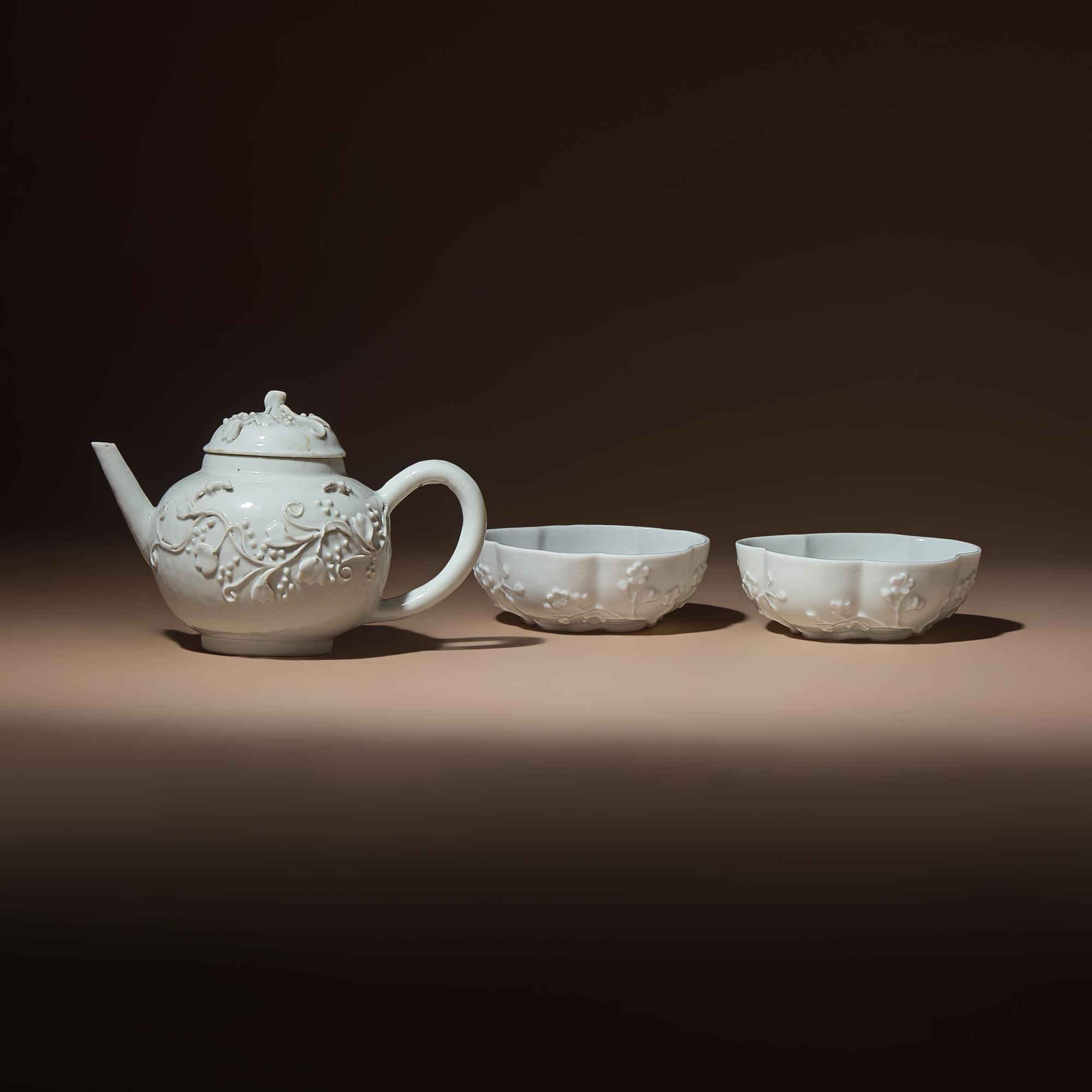A Chinese Blanc-de-Chine Molded Porcelain Covered Teapot and a Pair of Molded Floriform Bowls, 18th Century — 清中期 德化白瓷貼塑松鼠葡萄茶壺及茶碗一對