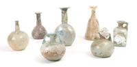 A Collection of Seven Roman Glass Bottles and Flasks, Height of tallest 6 inches.