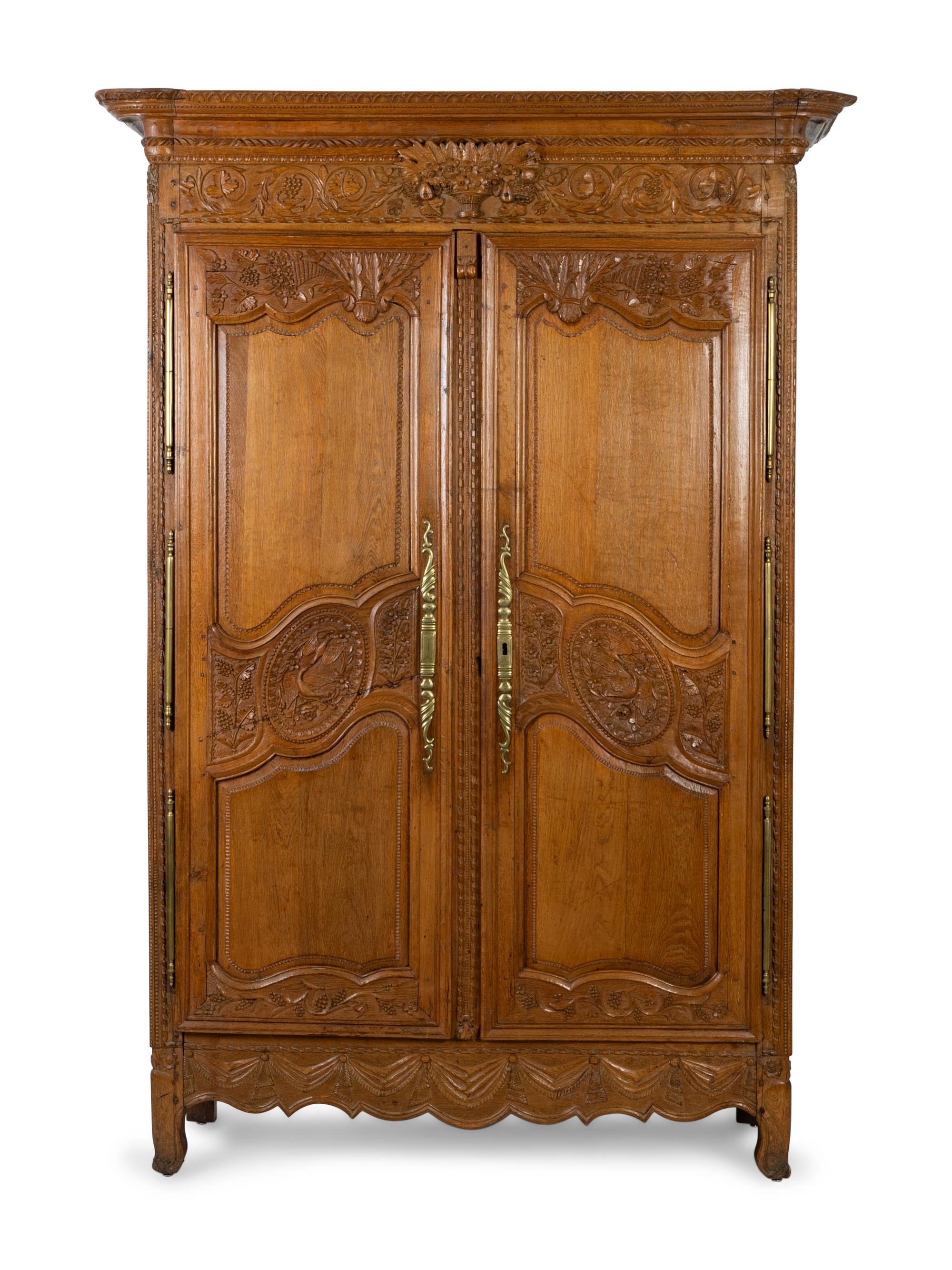 A Louis XV Provincial Style Carved Walnut Armoire