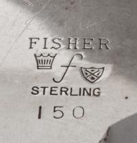 An American Silver Dish, Fisher Silversmiths, Newark, NJ, Mid-20th Century, formed as a shell and raised on three scroll supports.