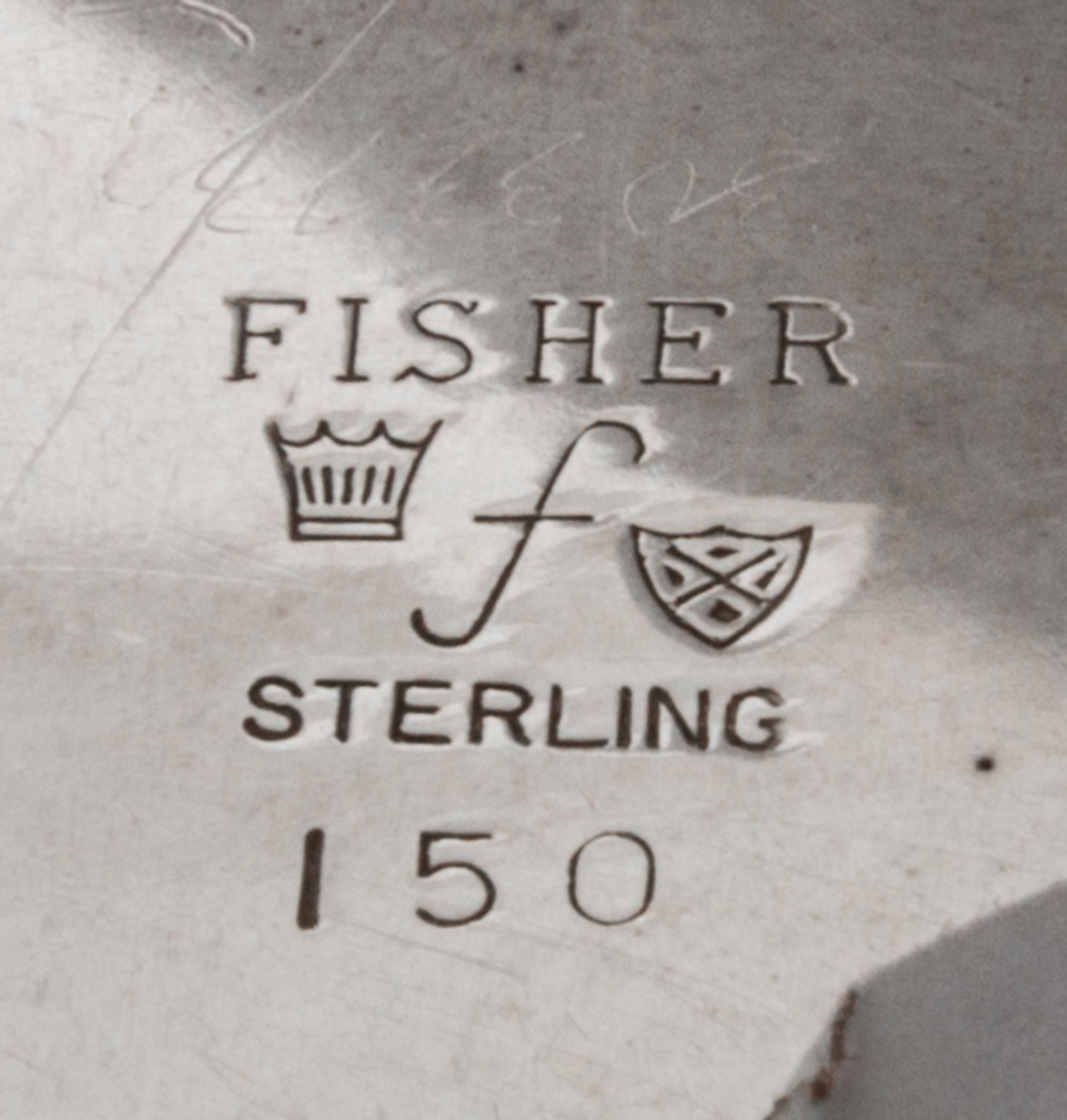 An American Silver Dish, Fisher Silversmiths, Newark, NJ, Mid-20th Century, formed as a shell and raised on three scroll supports.
