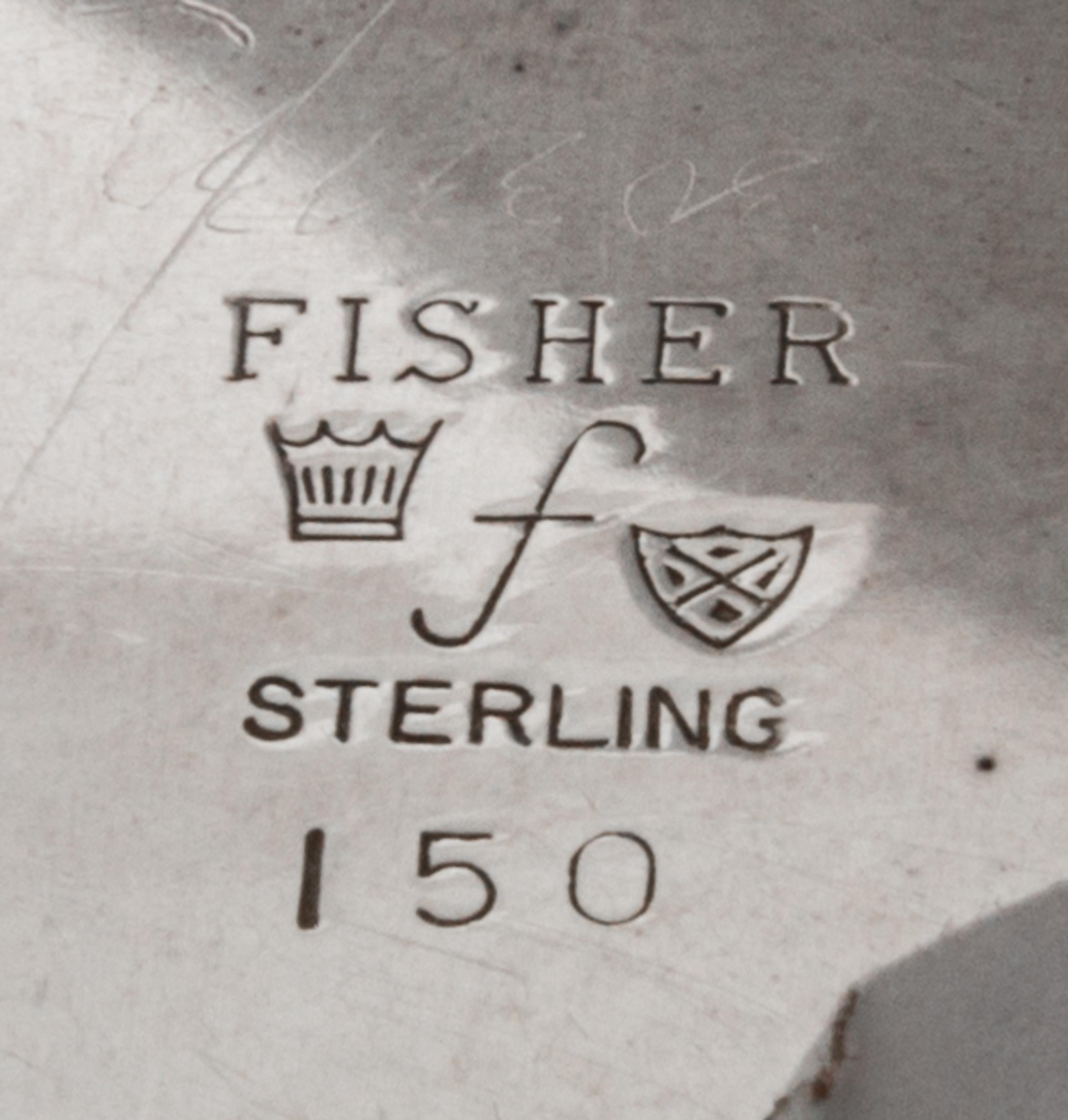 An American Silver Dish, Fisher Silversmiths, Newark, NJ, Mid-20th Century, formed as a shell and raised on three scroll supports.