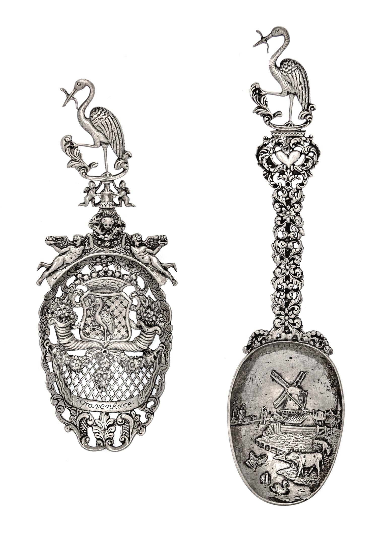 Two Dutch Silver Serving Spoons, Second Half 19th Century, comprsing a pierced example decorated with floral cornucopias and putti figu