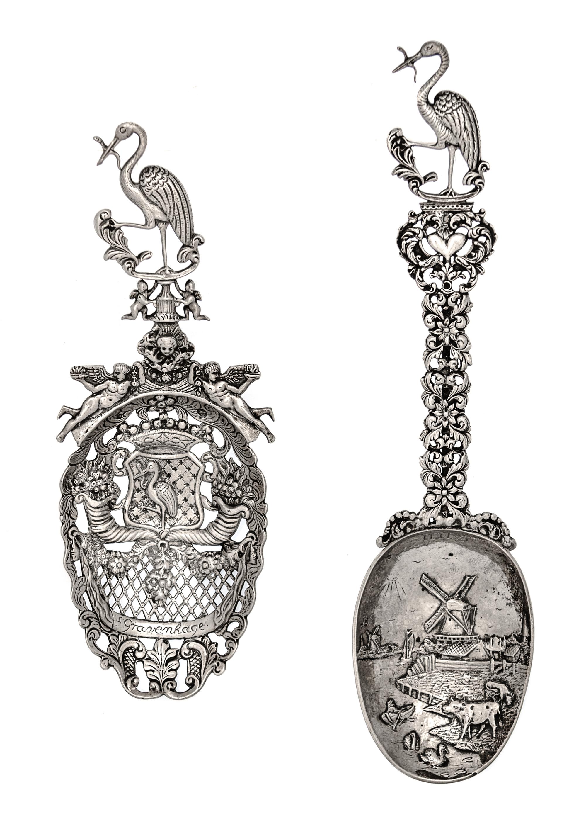 Two Dutch Silver Serving Spoons, Second Half 19th Century, comprsing a pierced example decorated with floral cornucopias and putti figu