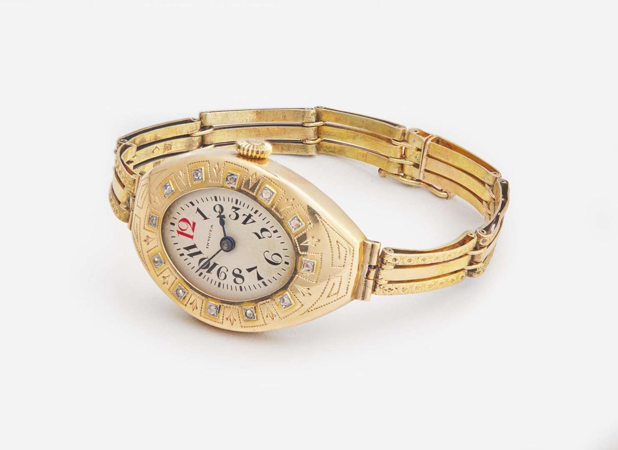 A Ladies 14K Yellow Gold Russian Invicta Watch with Diamonds
