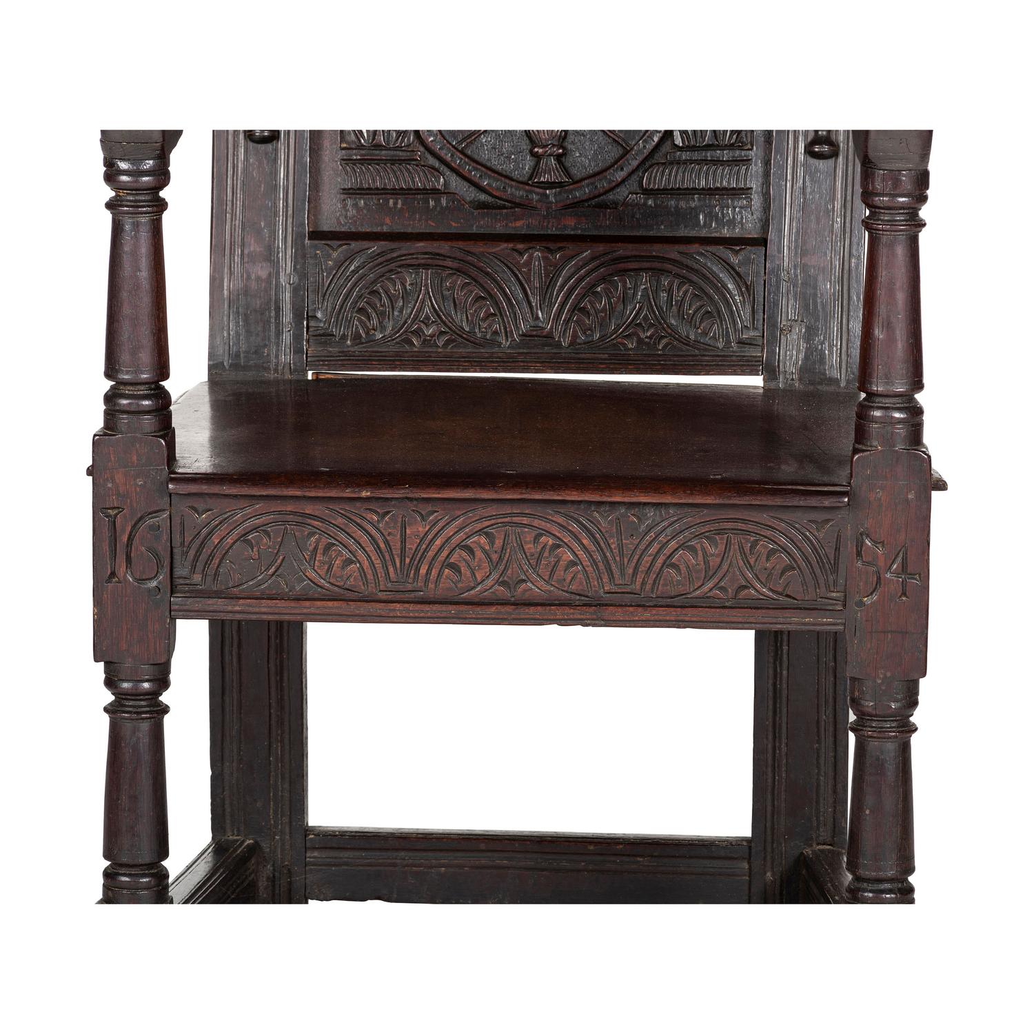 An English Carved Oak and Elm Panel-Back Armchair