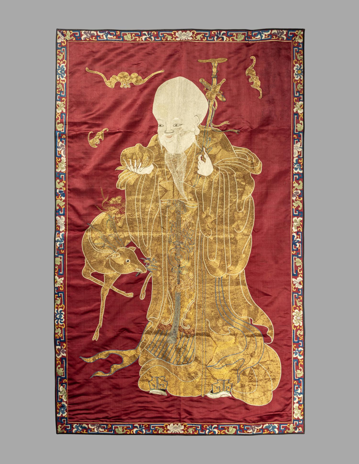 A Large Chinese Red Ground Embroidered Silk 'Longevity' Panel