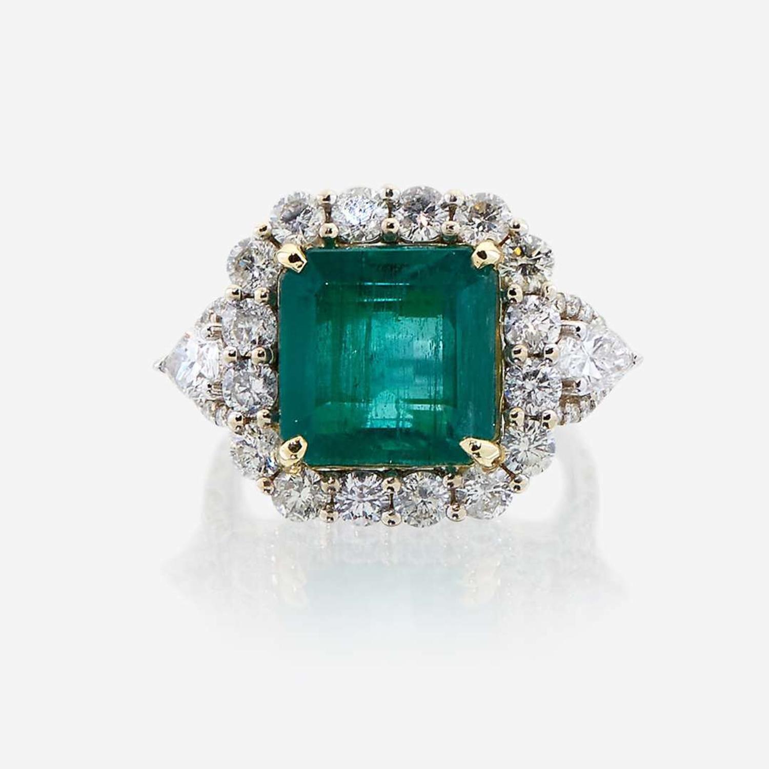 An emerald, diamond, and eighteen karat white gold ring