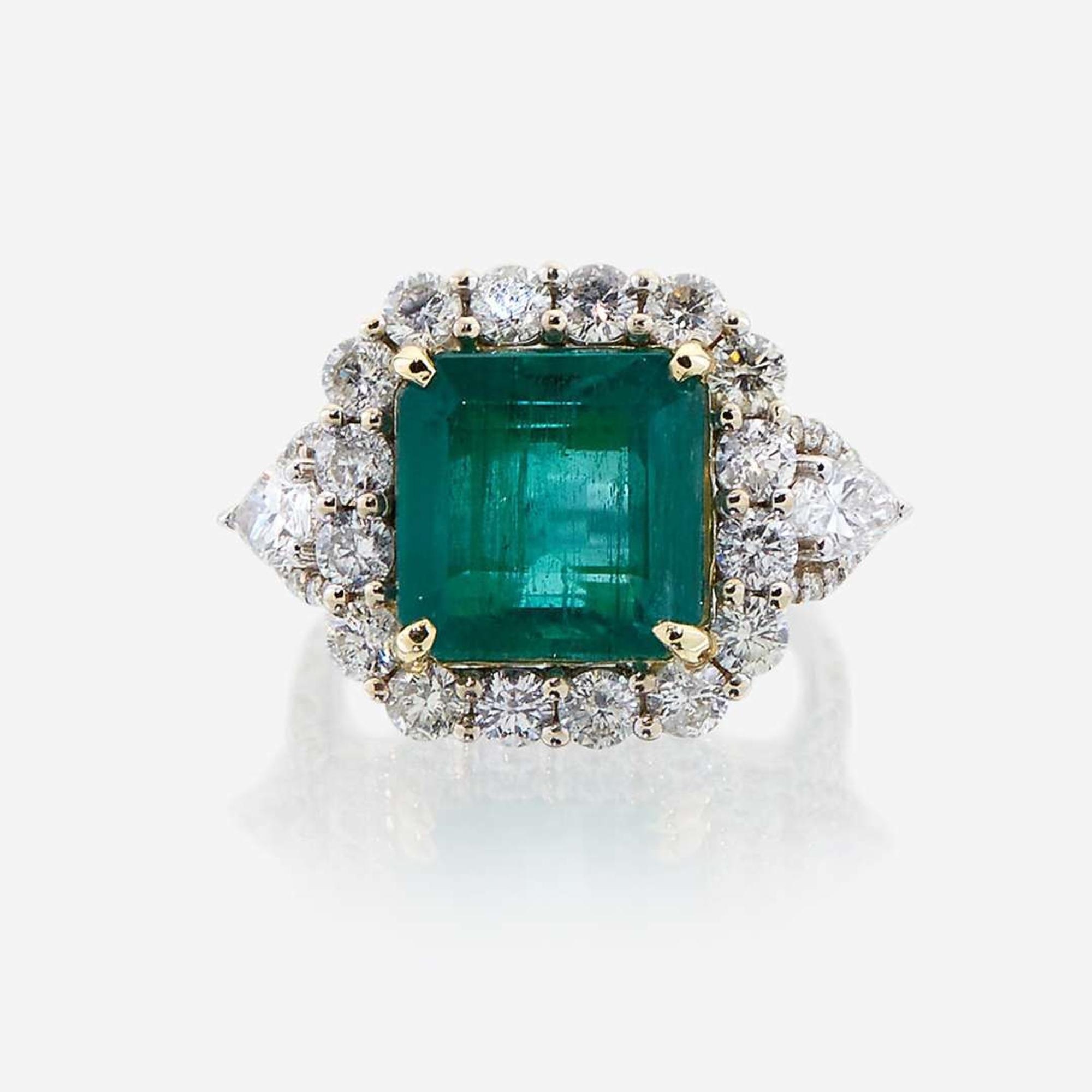 An emerald, diamond, and eighteen karat white gold ring