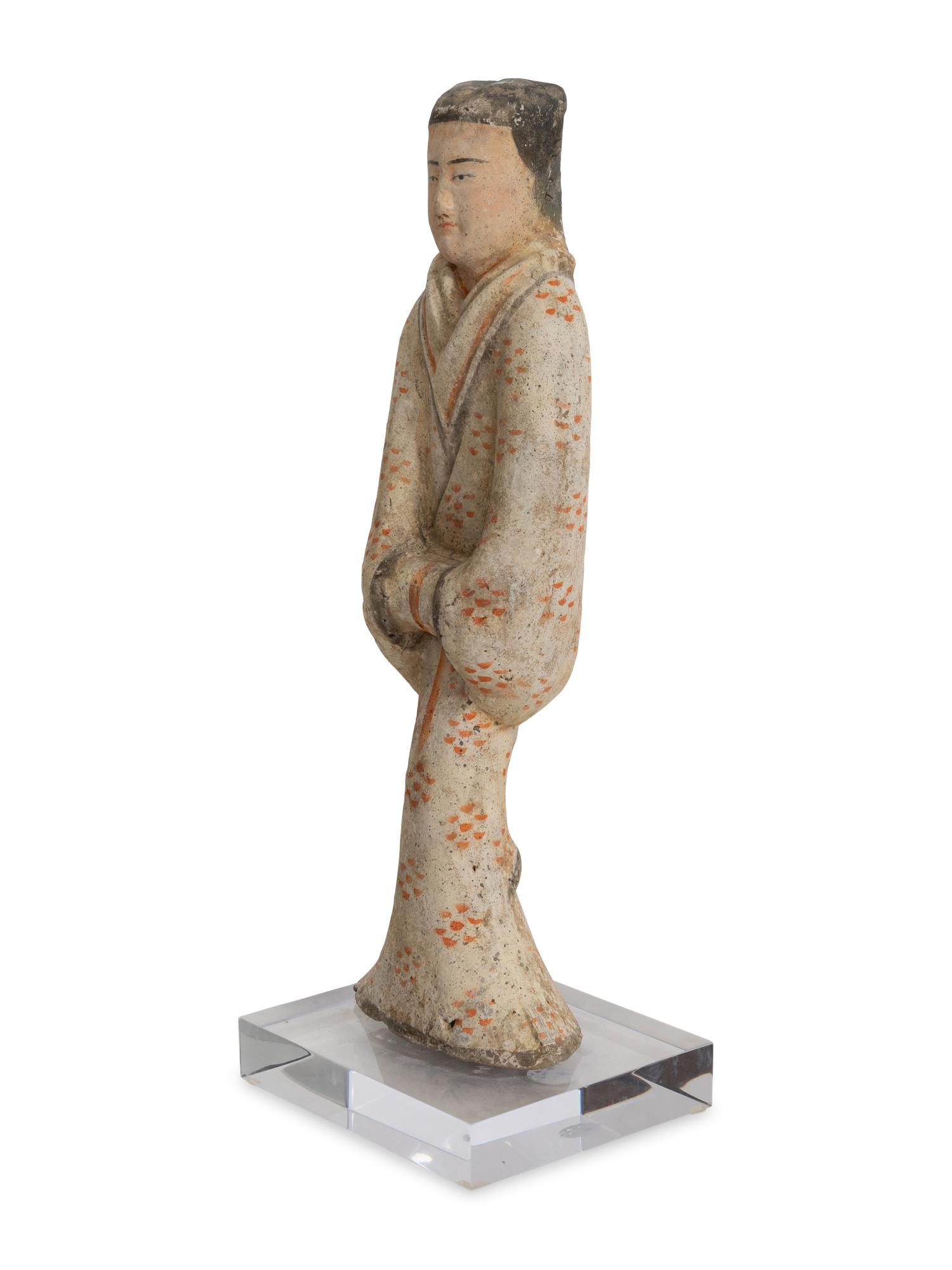 A Chinese Pottery Figure of a Female Attendant
