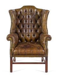 An English Leather Upholstered Mahogany Wingback Armchair