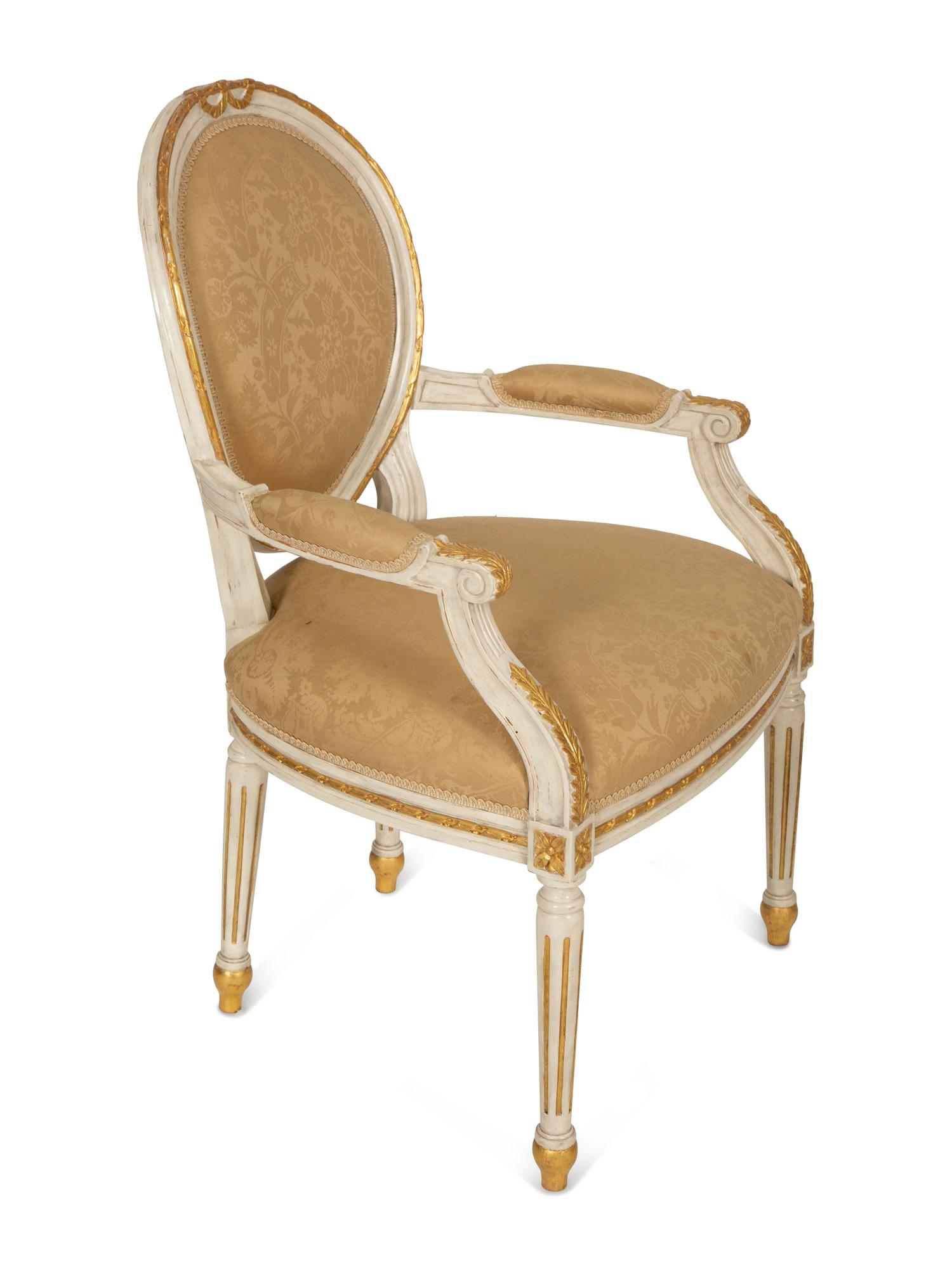 A Set of Eight Louis XVI Style Painted and Parcel Gilt Fauteuils